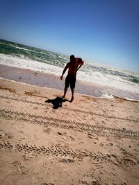 Full length of man on beach against sky