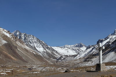 Snowcapped mountains against clear blue sky