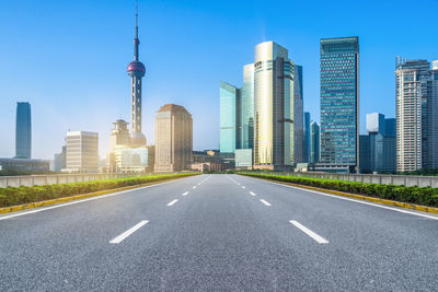 View of city buildings against blue sky