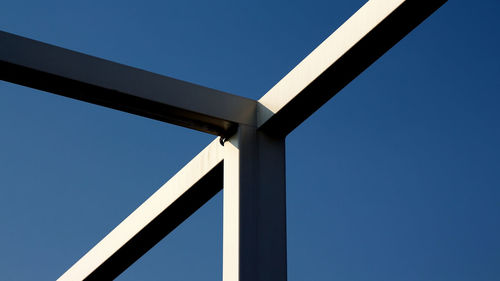 Low angle view of bridge against blue sky
