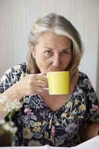 Senior woman drinking from mug
