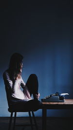 Woman sitting on table