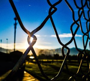 Close-up of metal against sky during sunset