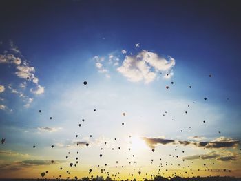 Low angle view of silhouette birds flying against sky