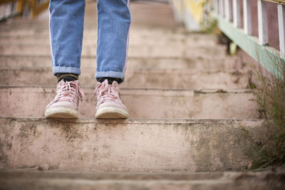 Low section of man standing on staircase