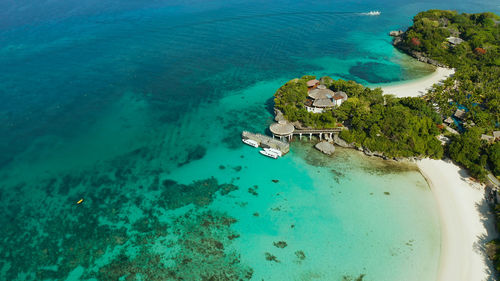 White sandy beach with tourists and hotels in boracay island, philippines, aerial view. 