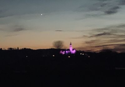 Silhouette landscape against sky at night