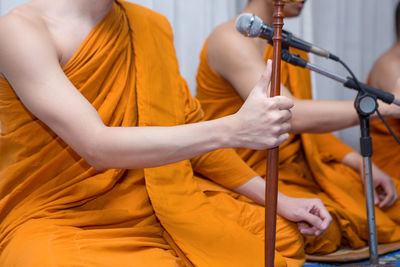 Midsection of monks singing