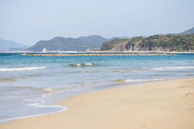 Scenic view of beach against clear sky