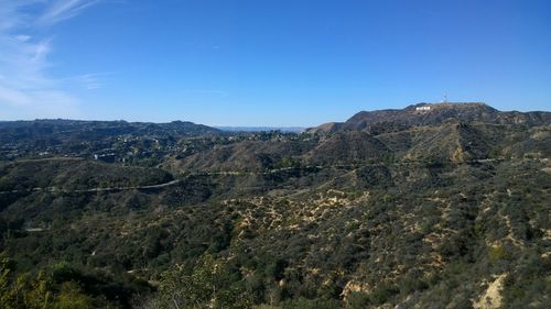 Scenic view of mountains against blue sky