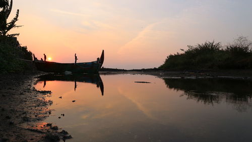Scenic view of lake against sky during sunset