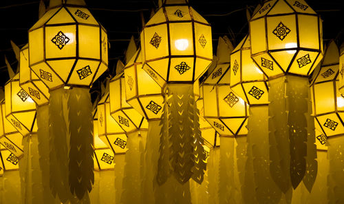 Full frame shot of yellow lanterns hanging and glowing in the street