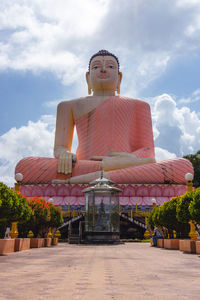 Statue of lord buddha against sky in kande viharaya  buddhits  temple in beruwala,sri lanka.