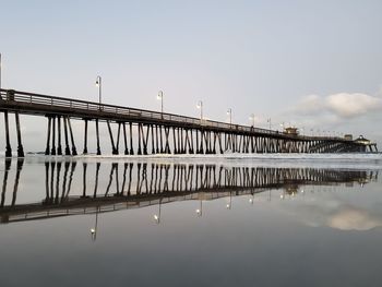 Bridge over sea against sky
