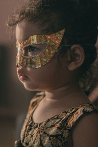 Close-up portrait of girl wearing mask