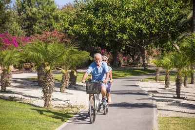 Portrait of man riding bicycle on plants