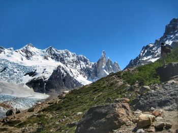 Scenic view of snowcapped mountains against clear blue sky