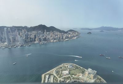 Aerial view of city by sea