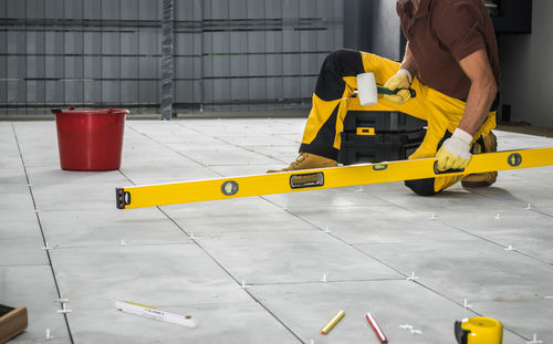 Low section of man skateboarding on floor