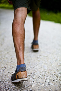 Low section of man running on road