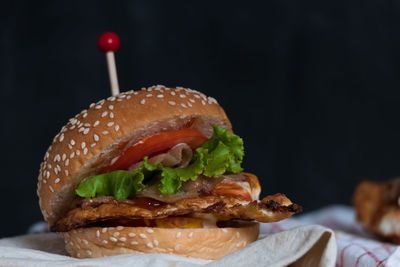 Close-up of hamburger against black background