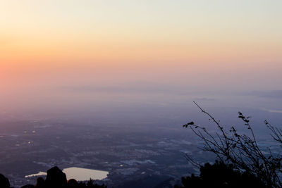 Scenic view of silhouette city against sky at sunset