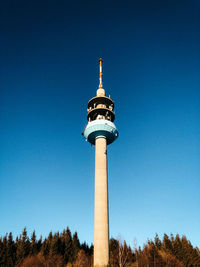 Low angle view of communications tower against sky