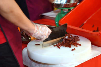 Midsection of man preparing food