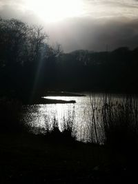 Scenic view of lake against sky at sunset