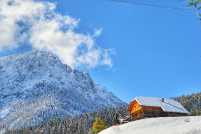 Scenic view of snowcapped mountains against blue sky