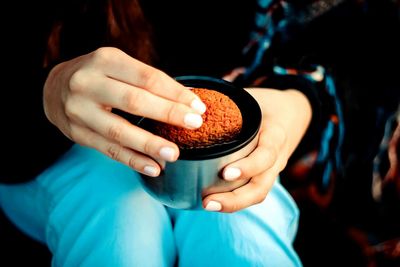 Midsection of woman having cookie