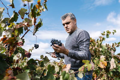 Man looking at camera against sky