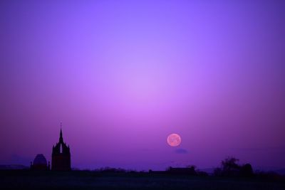 Scenic view of building against sky at dusk