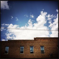 Low angle view of building against cloudy sky