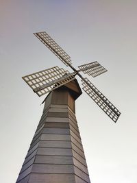 Low angle view of traditional windmill against sky