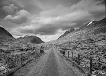 Scenic view of mountains against cloudy sky