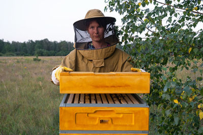 Portrait of smiling young woman standing on field