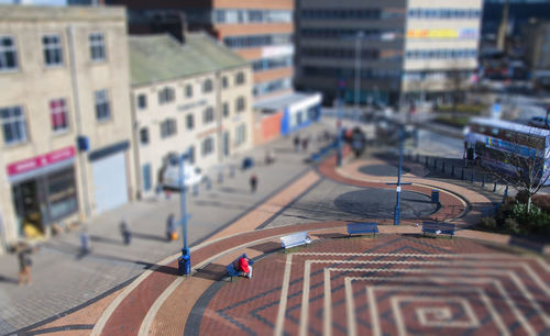 High angle view of vehicles on road along buildings