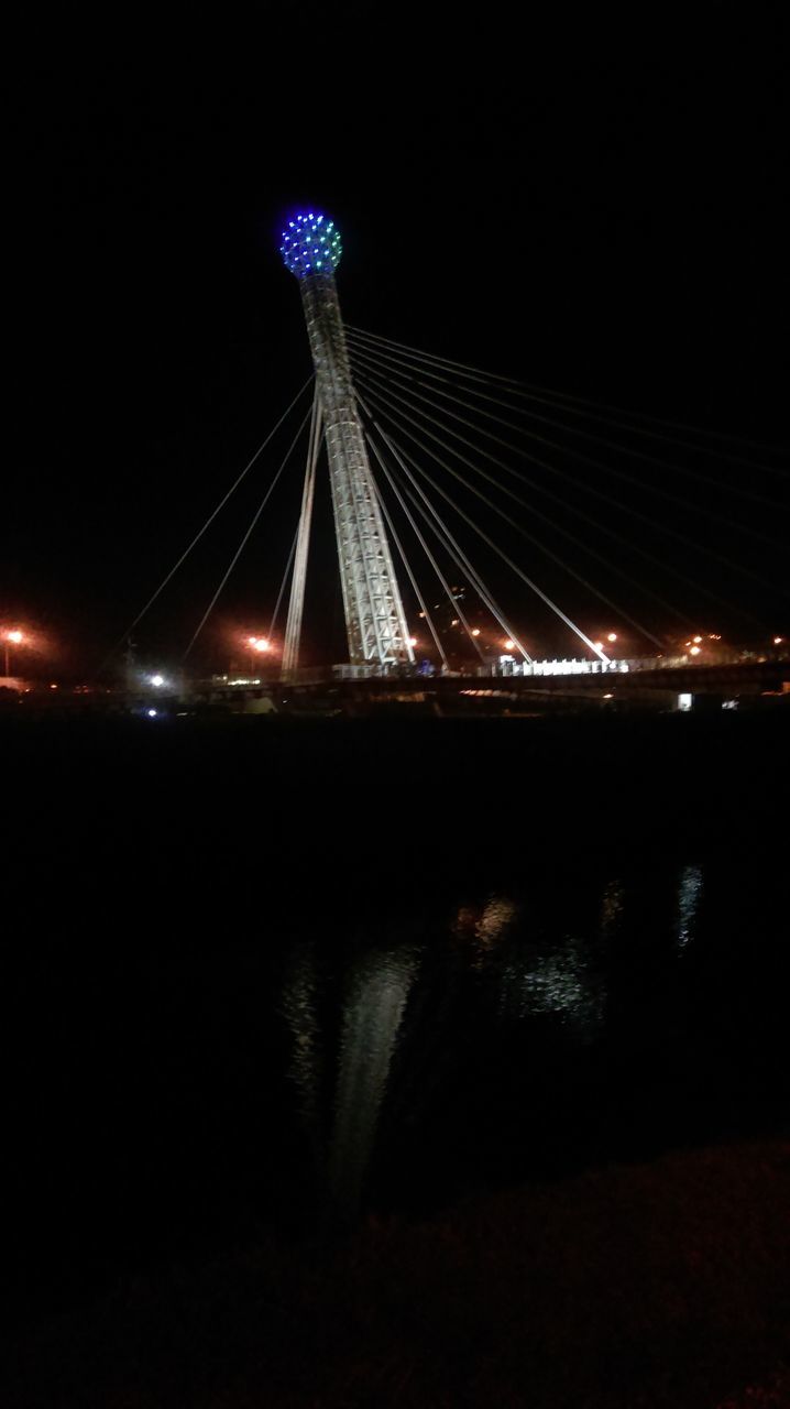 night, illuminated, built structure, connection, architecture, bridge - man made structure, engineering, long exposure, low angle view, sky, river, clear sky, arts culture and entertainment, dark, glowing, copy space, outdoors, city, lighting equipment, no people