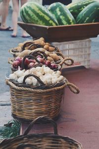 Close-up of onions for sale baskets in the street in food market