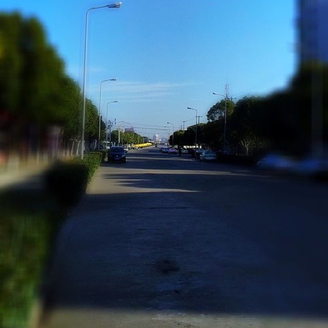 CARS ON STREET AGAINST SKY