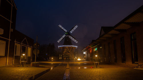 Low angle view of illuminated buildings against sky at night