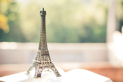 Close-up of mini eiffel tower on book