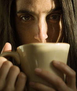 Close-up portrait of woman drinking coffee