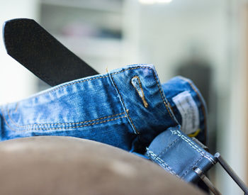 Close-up of jeans on seat at home