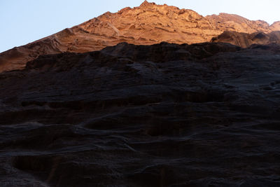 Low angle view of rock formation against clear sky