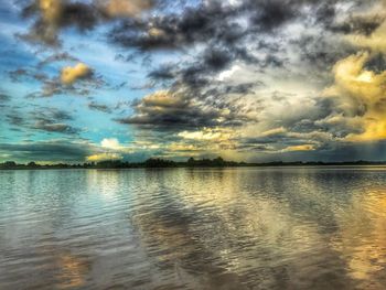 Scenic view of lake against sky at sunset