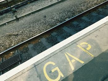High angle view of arrow symbol on railroad track