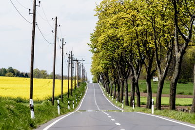 Empty road along countryside landscape