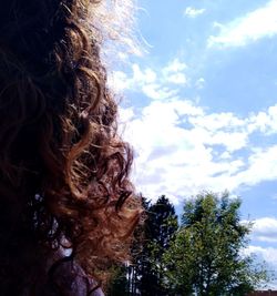 Low angle view of woman against sky